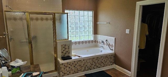 5322 Norborne Ln, Houston, TX 77069 - bathroom with a shower stall, a bath, a spacious closet, and a textured wall