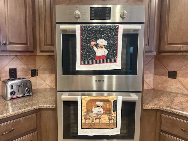 5322 Norborne Ln, Houston, TX 77069 - kitchen view of double oven, decorative backsplash, and light stone counters