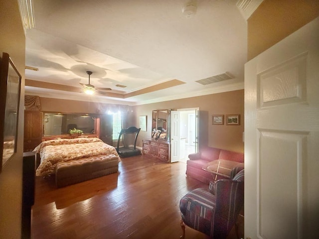 5322 Norborne Ln, Houston, TX 77069 - bedroom featuring a tray ceiling, ornamental molding, wood finished floors, and a ceiling fan