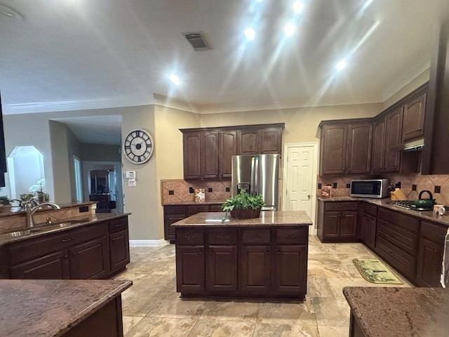 5322 Norborne Ln, Houston, TX 77069 - kitchen featuring stainless steel appliances, tasteful backsplash, dark brown cabinets, stone counters, and under cabinet range hood