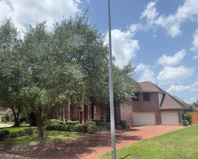 5322 Norborne Ln, Houston, TX 77069 - view of front of home with brick siding, driveway, a front lawn, and an attached garage