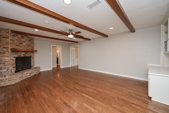 5906 Dumfries Dr, Houston, TX 77096 - unfurnished living room featuring beamed ceiling, ceiling fan, wood finished floors, a brick fireplace, and recessed lighting