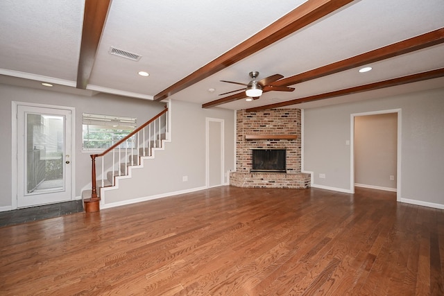5906 Dumfries Dr, Houston, TX 77096 - unfurnished living room with ceiling fan, beamed ceiling, stairway, wood finished floors, and a fireplace