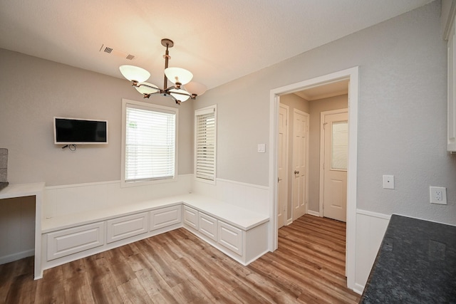 5906 Dumfries Dr, Houston, TX 77096 - unfurnished dining area featuring a chandelier and light wood-style flooring