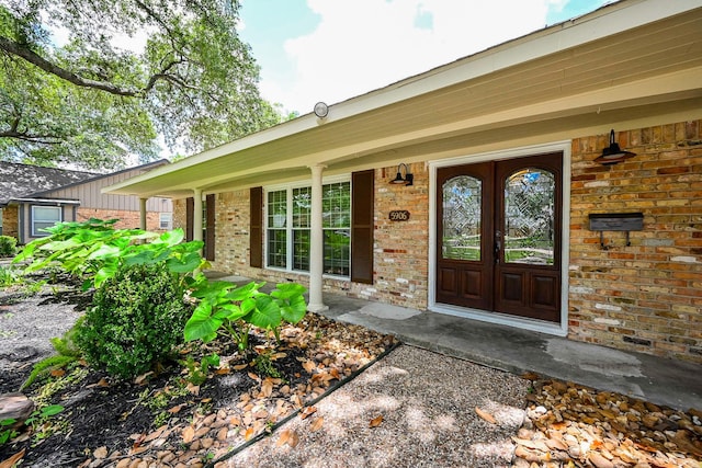 5906 Dumfries Dr, Houston, TX 77096 - view of exterior entry featuring brick siding and covered porch