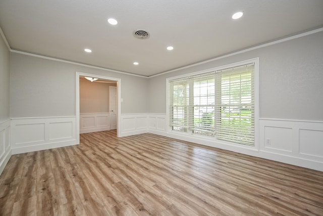 5906 Dumfries Dr, Houston, TX 77096 - spare room featuring ornamental molding, a decorative wall, wainscoting, recessed lighting, and light wood finished floors