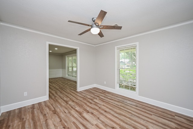 5906 Dumfries Dr, Houston, TX 77096 - spare room featuring ornamental molding, ceiling fan, light wood-style flooring, and healthy amount of natural light