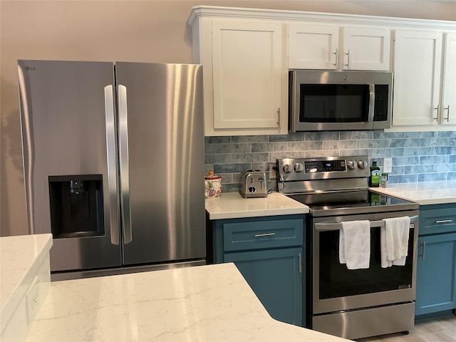 19 Trail Lk, Trinity, TX 75862 - kitchen with appliances with stainless steel finishes, tasteful backsplash, white cabinetry, and blue cabinets