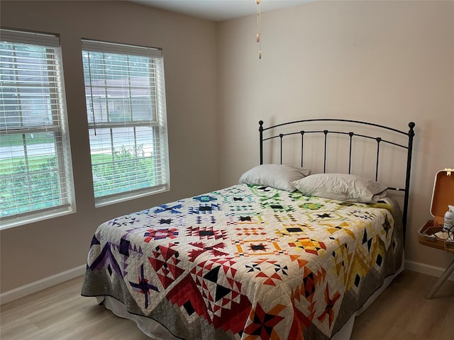 19 Trail Lk, Trinity, TX 75862 - bedroom with light wood-style floors and multiple windows