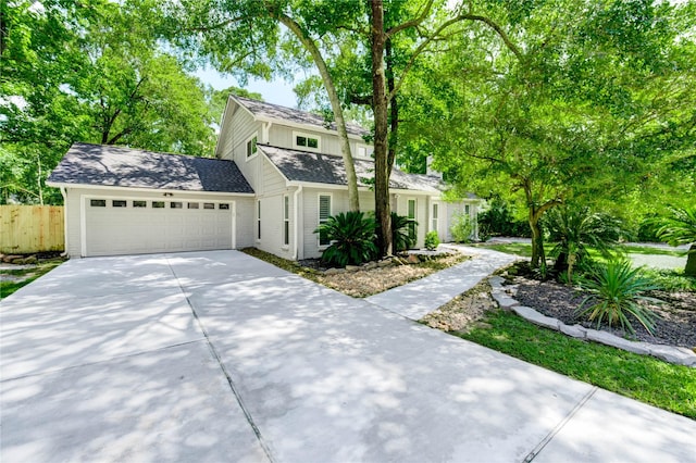 1904 Nursery Rd, The Woodlands, TX 77380 - traditional-style home with concrete driveway, a garage, brick siding, board and batten siding, and a shingled roof