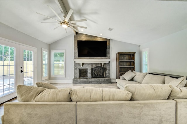 1904 Nursery Rd, The Woodlands, TX 77380 - living area featuring wood finished floors, french doors, ceiling fan, and a brick fireplace
