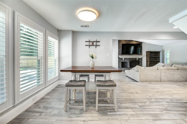 1904 Nursery Rd, The Woodlands, TX 77380 - dining room with wood finished floors and a brick fireplace