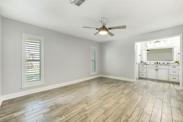 1904 Nursery Rd, The Woodlands, TX 77380 - unfurnished living room featuring plenty of natural light, light wood-type flooring, and a ceiling fan