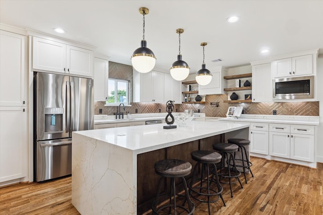 805 English St, Houston, TX 77009 - kitchen featuring appliances with stainless steel finishes, open shelves, white cabinetry, backsplash, and recessed lighting