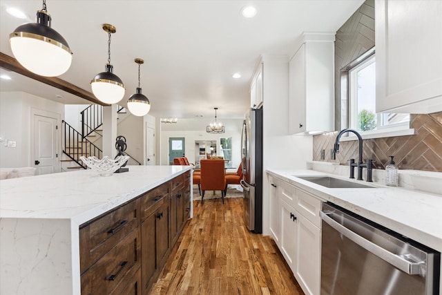 805 English St, Houston, TX 77009 - kitchen featuring stainless steel appliances, backsplash, plenty of natural light, white cabinets, and recessed lighting