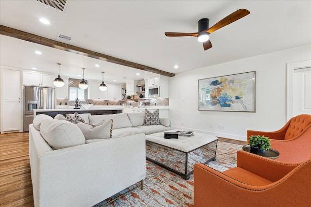 805 English St, Houston, TX 77009 - living room with a ceiling fan, recessed lighting, light wood finished floors, and beam ceiling