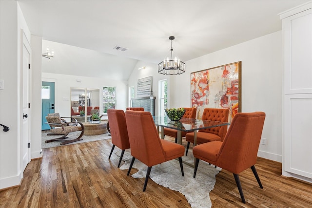 805 English St, Houston, TX 77009 - dining room with a chandelier, wood finished floors, and lofted ceiling