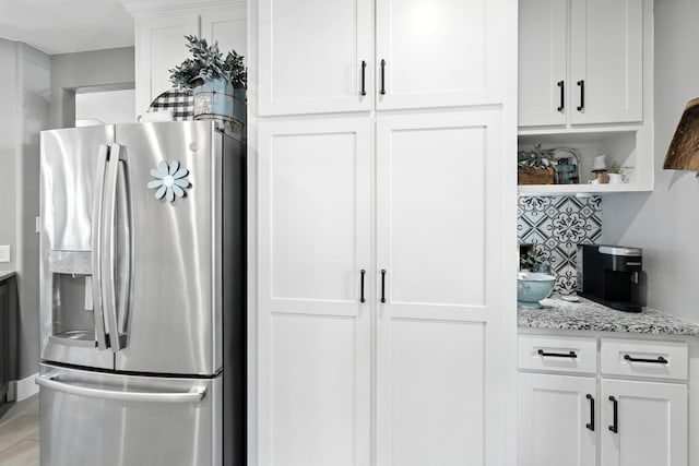 14506 Heron Marsh Dr, Cypress, TX 77429 - kitchen featuring stainless steel refrigerator with ice dispenser, white cabinetry, light stone counters, and open shelves
