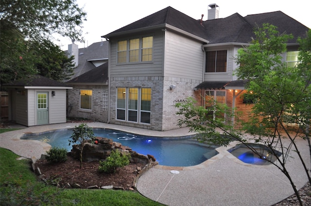 21827 Barton Park Ln, Katy, TX 77450 - back of house featuring a chimney, brick siding, an outdoor pool, and a patio area