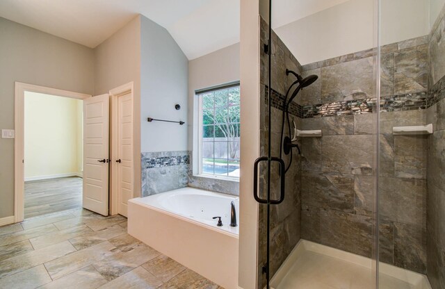 21827 Barton Park Ln, Katy, TX 77450 - bathroom featuring a bath, a stall shower, and lofted ceiling