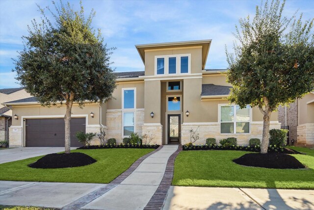 190 Monarch Trl, Sugar Land, TX 77498 - view of front of house featuring stone siding, stucco siding, a front yard, and concrete driveway