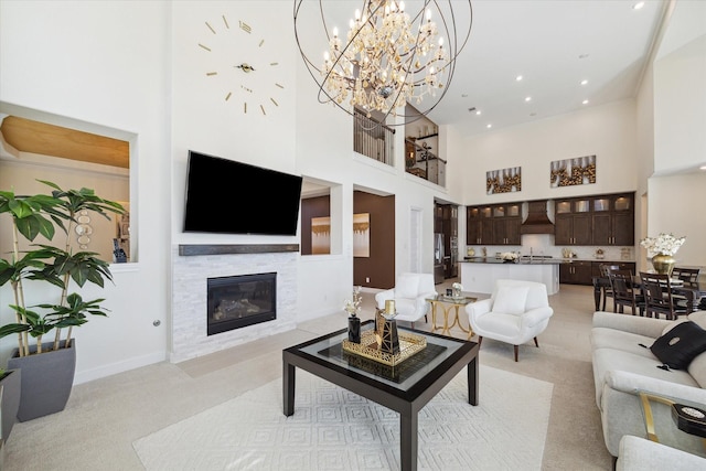 190 Monarch Trl, Sugar Land, TX 77498 - living room with a high ceiling, light colored carpet, a glass covered fireplace, a chandelier, and recessed lighting