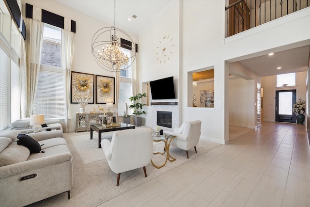 190 Monarch Trl, Sugar Land, TX 77498 - living room with a towering ceiling, a chandelier, and a glass covered fireplace