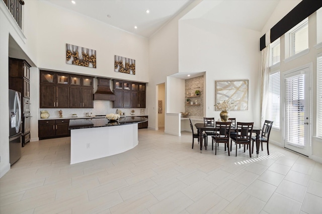 190 Monarch Trl, Sugar Land, TX 77498 - kitchen featuring high vaulted ceiling, tasteful backsplash, dark brown cabinetry, glass insert cabinets, and appliances with stainless steel finishes