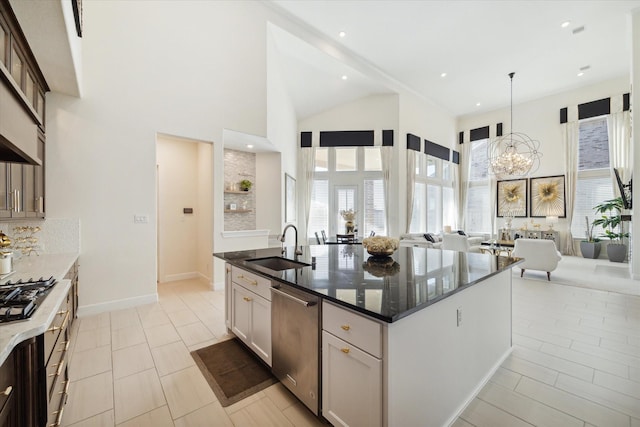 190 Monarch Trl, Sugar Land, TX 77498 - kitchen with stainless steel dishwasher, open floor plan, a chandelier, dark stone counters, and an island with sink