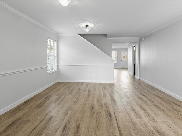 5031 Rustling Branch Ln, Katy, TX 77449 - unfurnished living room featuring wood finished floors, ornamental molding, and stairs
