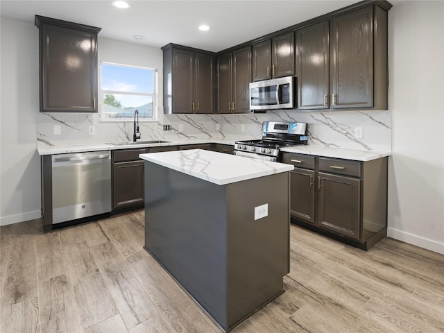 5031 Rustling Branch Ln, Katy, TX 77449 - kitchen featuring stainless steel appliances, light wood-style floors, backsplash, and recessed lighting