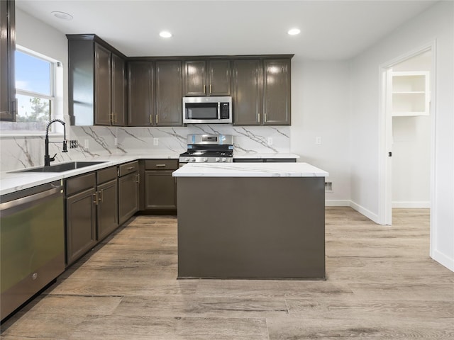5031 Rustling Branch Ln, Katy, TX 77449 - kitchen featuring appliances with stainless steel finishes, light wood-type flooring, tasteful backsplash, recessed lighting, and dark brown cabinetry