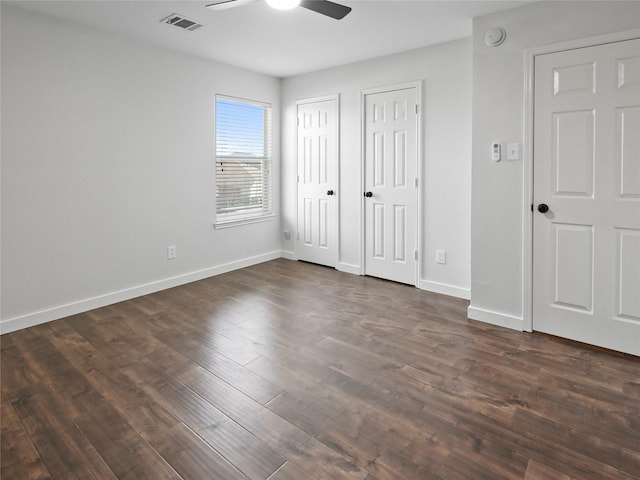 5031 Rustling Branch Ln, Katy, TX 77449 - unfurnished bedroom with multiple closets, dark wood-style flooring, and a ceiling fan