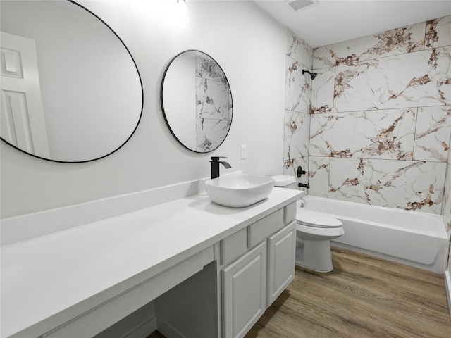 5031 Rustling Branch Ln, Katy, TX 77449 - bathroom with vanity, washtub / shower combination, and wood finished floors