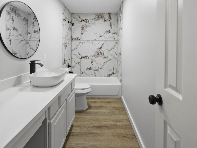 5031 Rustling Branch Ln, Katy, TX 77449 - bathroom with vanity, wood finished floors, and shower / bathtub combination