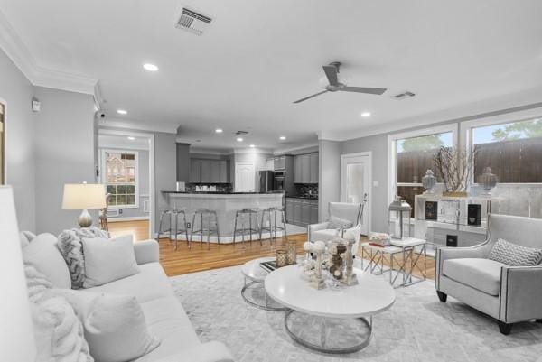 5603 Dolores St, Houston, TX 77057 - living room with crown molding, recessed lighting, a ceiling fan, and light wood-style flooring