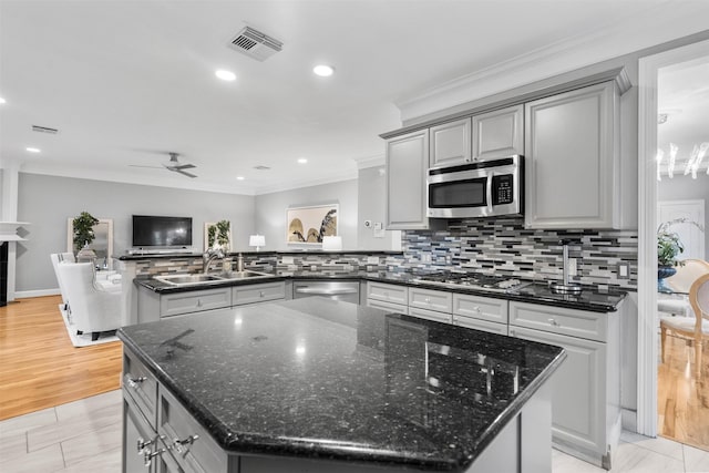 5603 Dolores St, Houston, TX 77057 - kitchen featuring stainless steel appliances, gray cabinetry, a peninsula, a center island, and crown molding