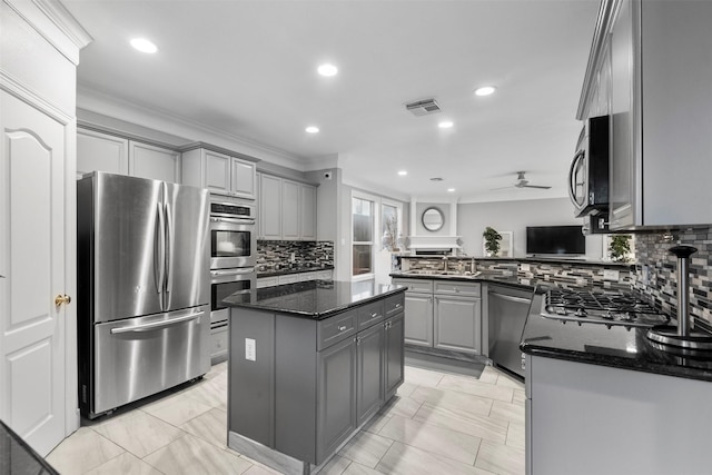 5603 Dolores St, Houston, TX 77057 - kitchen with stainless steel appliances, gray cabinets, recessed lighting, a ceiling fan, and decorative backsplash