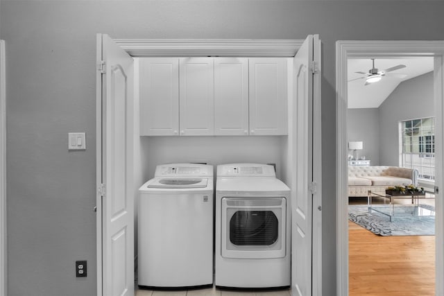 5603 Dolores St, Houston, TX 77057 - laundry room featuring cabinet space, washing machine and dryer, and a ceiling fan