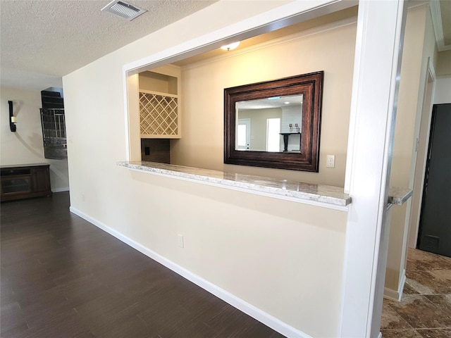 711 Holly Springs Dr, Conroe, TX 77302 - hall featuring dark wood-style flooring and a textured ceiling