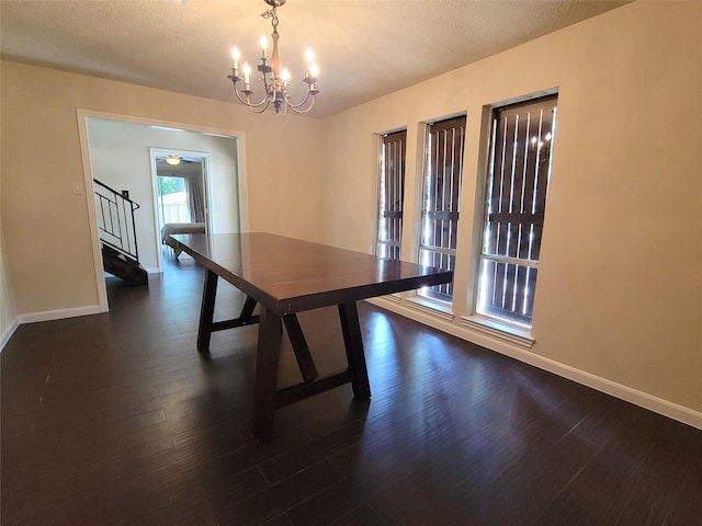 711 Holly Springs Dr, Conroe, TX 77302 - unfurnished dining area featuring stairs, a chandelier, dark wood-style floors, and a textured ceiling