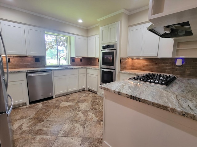 711 Holly Springs Dr, Conroe, TX 77302 - kitchen featuring stainless steel appliances, backsplash, exhaust hood, white cabinetry, and light stone countertops