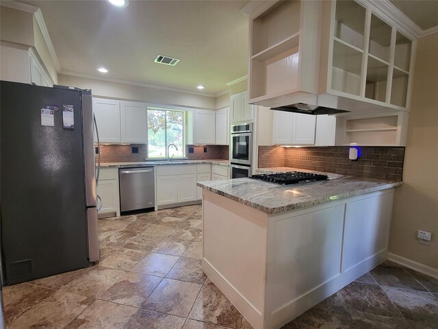 711 Holly Springs Dr, Conroe, TX 77302 - kitchen featuring stainless steel appliances, open shelves, ornamental molding, stone tile flooring, and light stone countertops