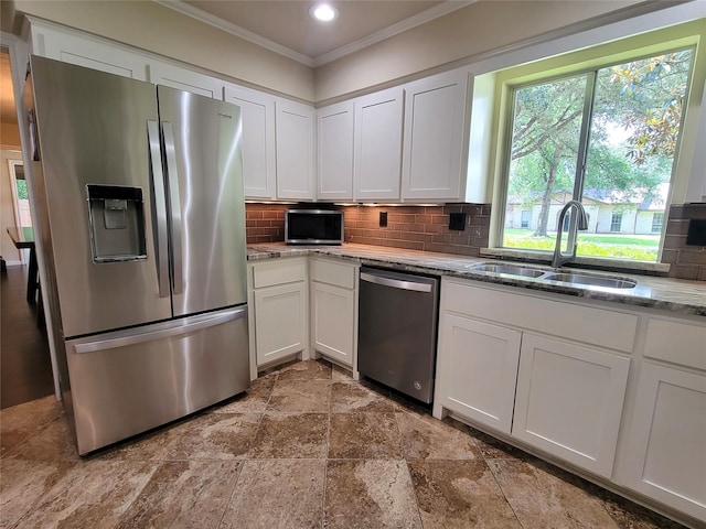 711 Holly Springs Dr, Conroe, TX 77302 - kitchen featuring appliances with stainless steel finishes, crown molding, white cabinets, backsplash, and recessed lighting