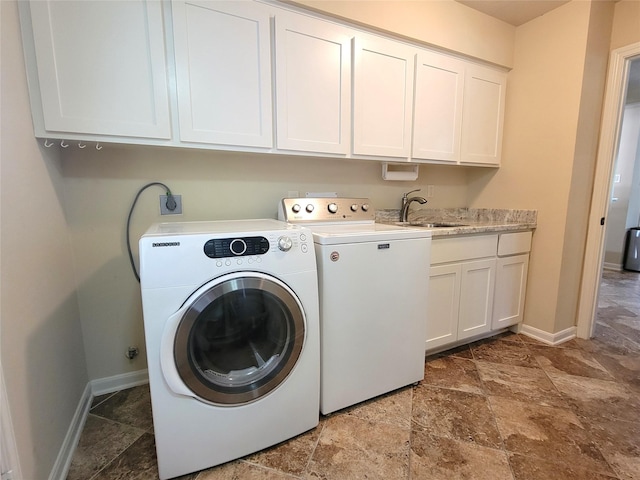 711 Holly Springs Dr, Conroe, TX 77302 - washroom with cabinet space, washing machine and clothes dryer, and stone finish floors