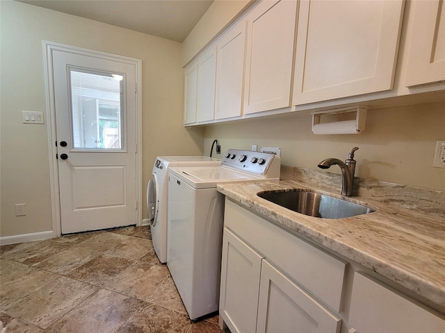711 Holly Springs Dr, Conroe, TX 77302 - laundry room featuring cabinet space, washing machine and clothes dryer, and light stone finish flooring
