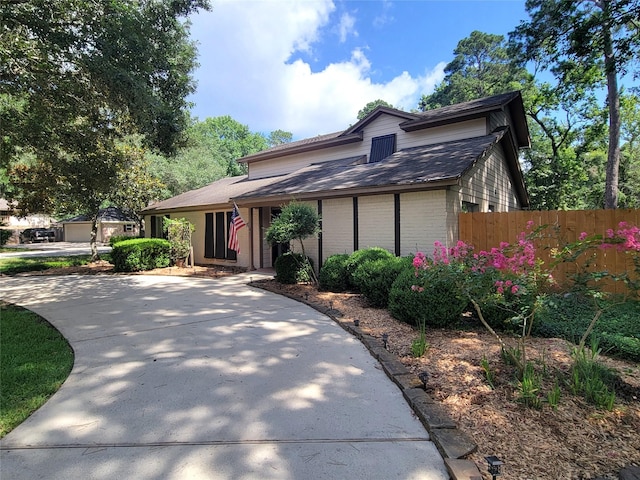 711 Holly Springs Dr, Conroe, TX 77302 - view of front of home featuring brick siding and roof with shingles