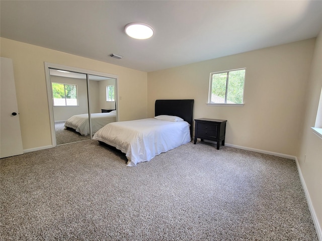 711 Holly Springs Dr, Conroe, TX 77302 - bedroom featuring carpet flooring, multiple windows, and a closet