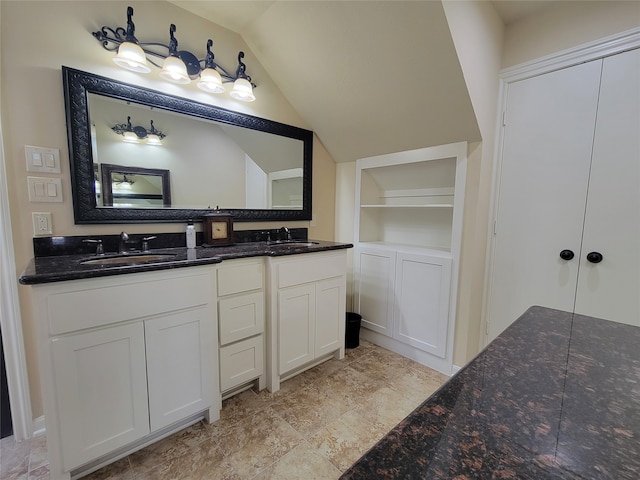 711 Holly Springs Dr, Conroe, TX 77302 - bathroom featuring double vanity, vaulted ceiling, and built in features