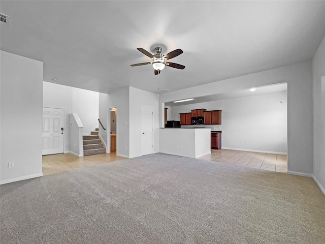 211 Golden Eagle Ct, La Marque, TX 77568 - unfurnished living room featuring a ceiling fan, light tile patterned floors, light colored carpet, and stairs